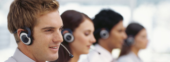 side profile of four business executives wearing headsets in an office